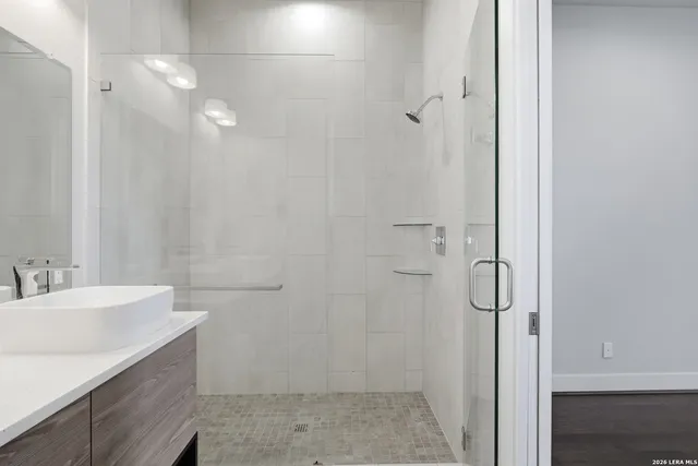 a bathroom with a sink a toilet and shower