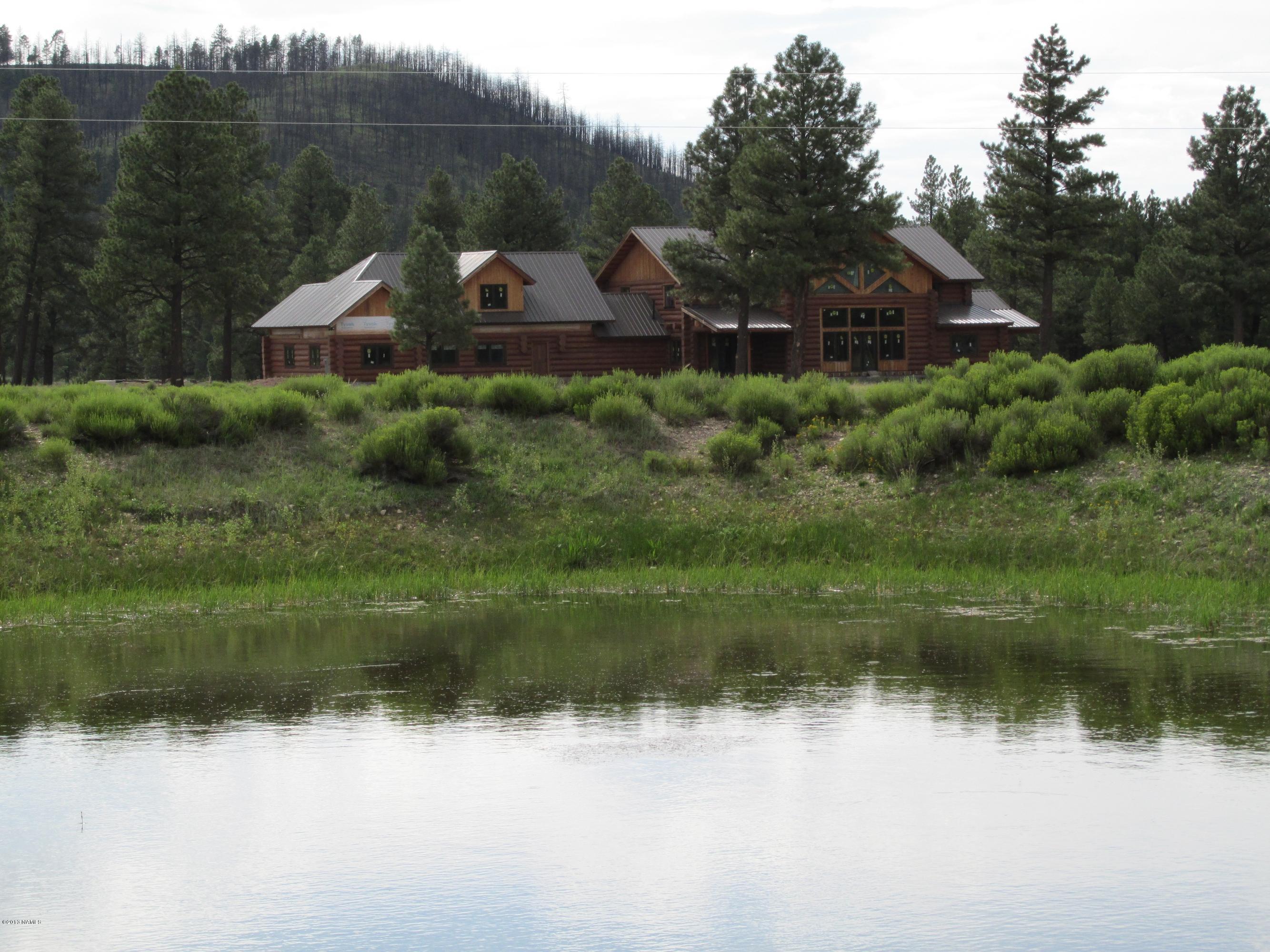 12694 North Spring Valley Road Parks, AZ 86018 - Photo 1 of 23 Log Home & Pond