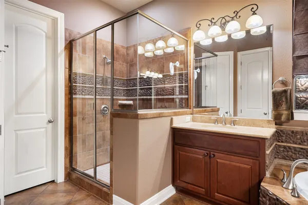 a kitchen with stainless steel appliances granite countertop a table chairs refrigerator and sink