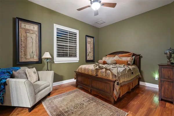 a kitchen with stainless steel appliances granite countertop a stove a sink dishwasher and cabinets with wooden floor