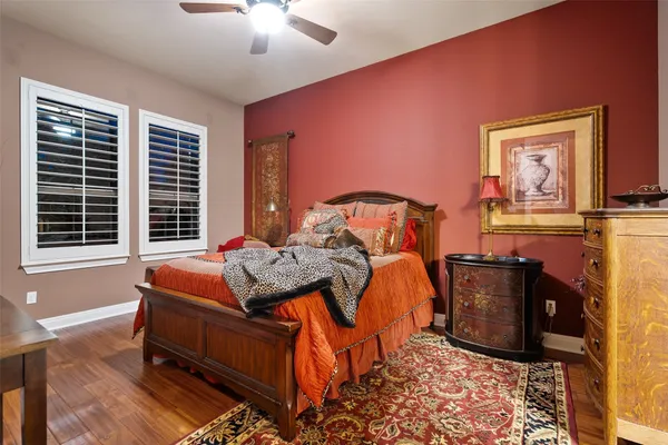 a bedroom with furniture and a rug