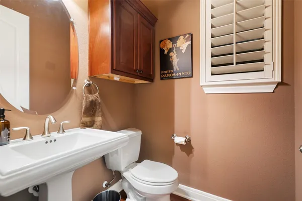 a bathroom with a sink a toilet and mirror