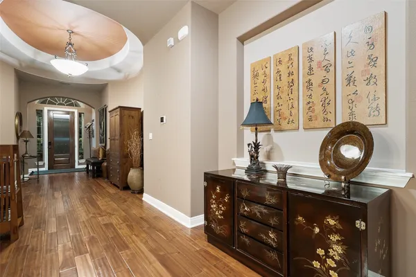 a view of a room that has a bed and a chandelier