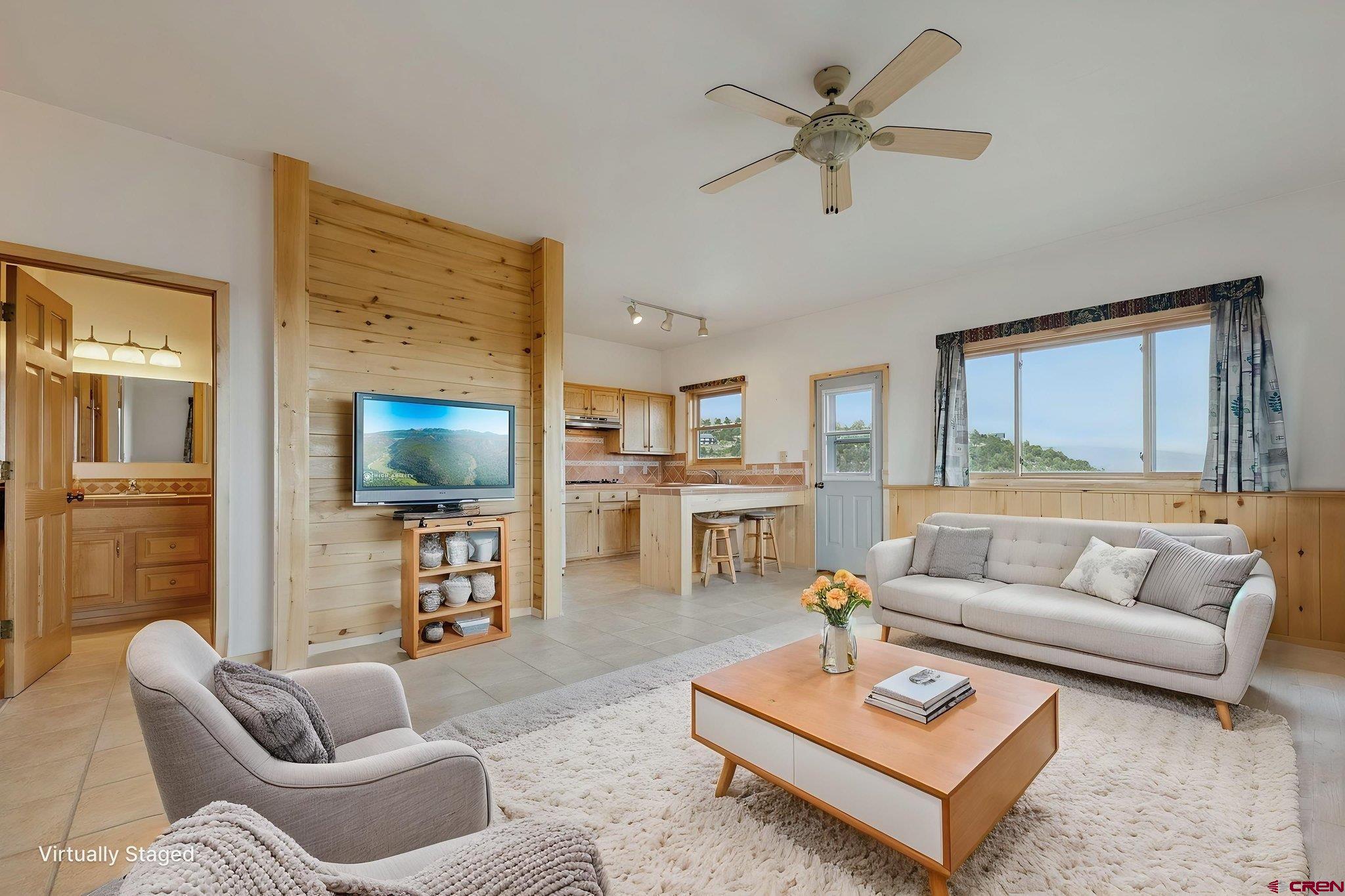 481 Far View Road Durango, CO 81303 - Photo 27 of 45 a living room with furniture a rug and a flat screen tv