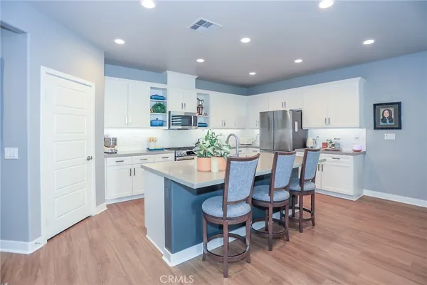 a kitchen with a stove a sink and a refrigerator