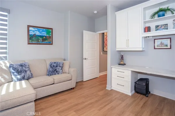 a living room filled with furniture and a potted plant