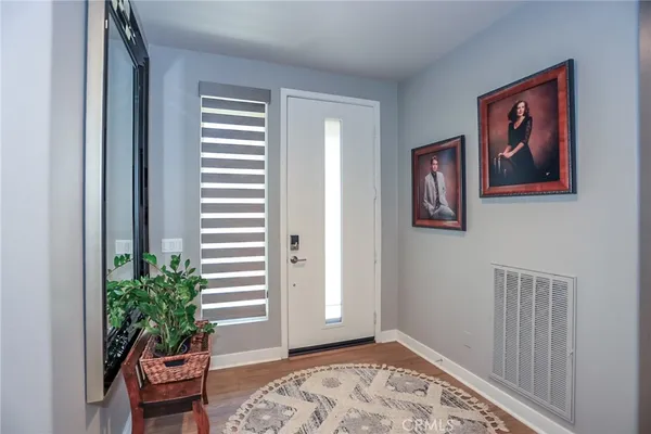 a living room with furniture a wooden floor and a large window