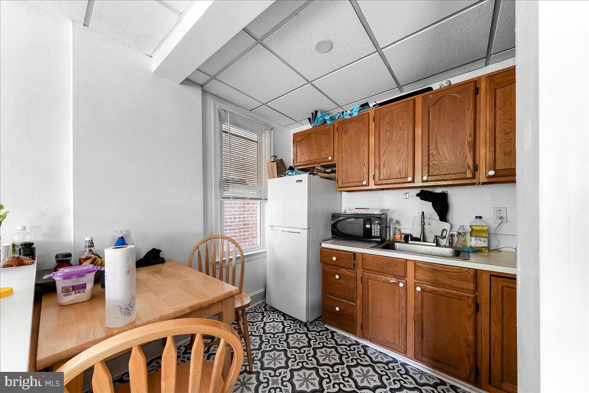 13 South Chester Road Swarthmore, PA 19081 - Photo 25 of 48 a kitchen with stainless steel appliances granite countertop a sink dishwasher stove and refrigerator with wooden floor