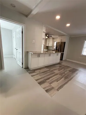 a kitchen with stainless steel appliances a stove a microwave and white cabinets