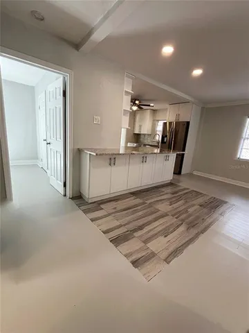 a kitchen with stainless steel appliances a stove a microwave and white cabinets