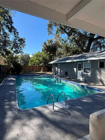 a view of backyard with a slide and table