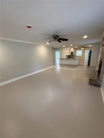 a large kitchen with granite countertop a sink stainless steel appliances and cabinets
