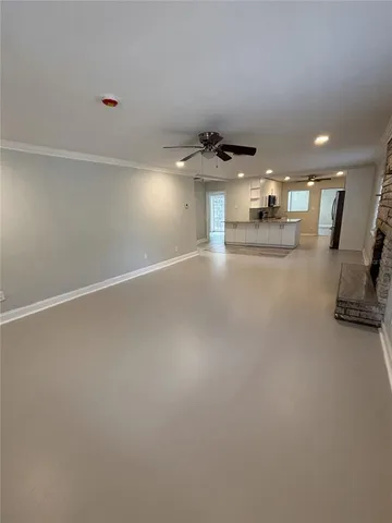 a large kitchen with granite countertop a sink stainless steel appliances and cabinets