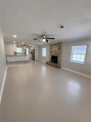 a large kitchen with kitchen island a sink stainless steel appliances and cabinets