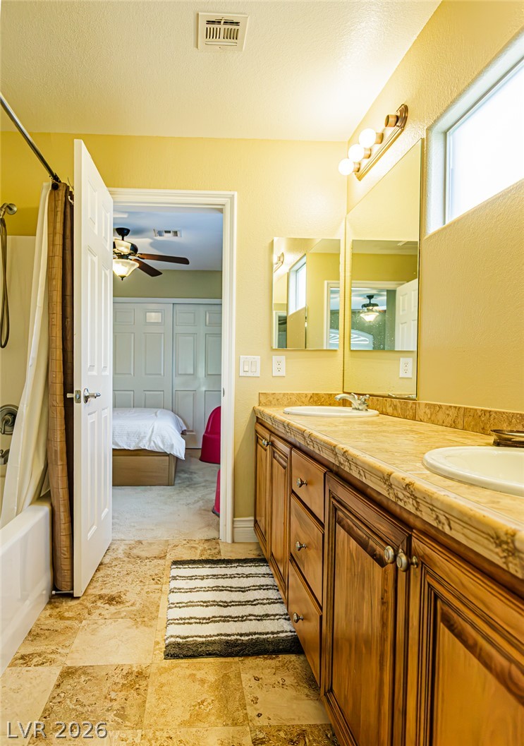 75 Tall Ruff Drive Las Vegas, NV 89148 - Photo 28 of 64 Tiled flooring and a long double vanity anchor this highly functional secondary bathroom layout.