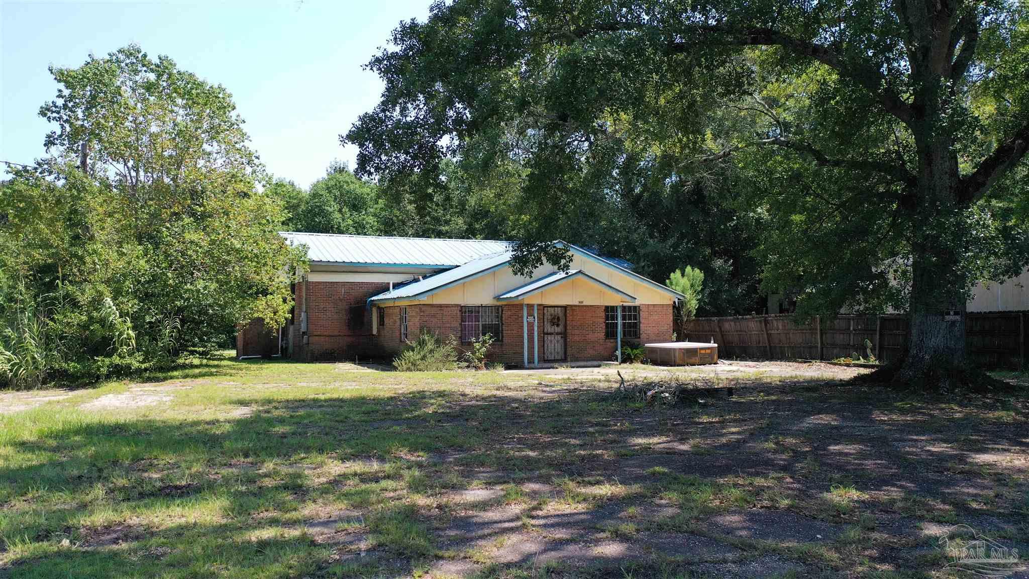 612 North Main Street Atmore, AL 36502 - Photo 10 of 12 a view of a house with a yard
