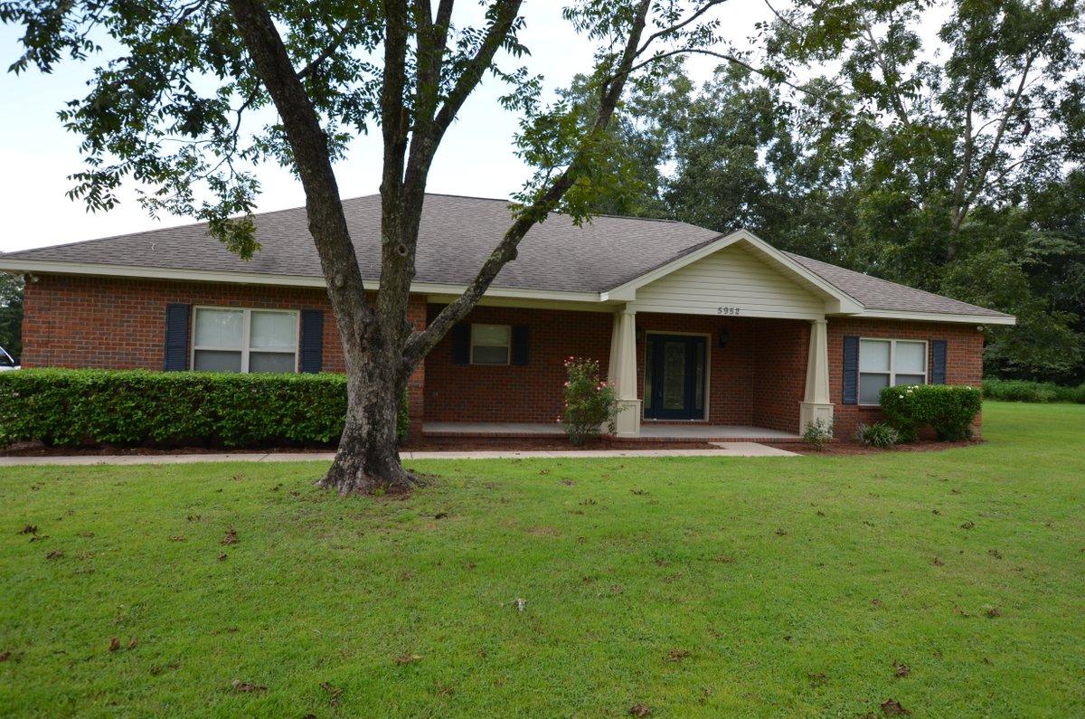 5952 Old Bethel Road Crestview, FL 32536 - Photo 1 of 25 a front view of a house with a garden