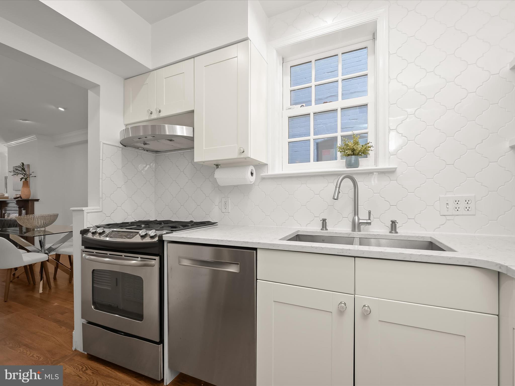 3407 Q Street Northwest Washington, DC 20007 - Photo 14 of 27 a kitchen with stainless steel appliances white cabinets and a sink