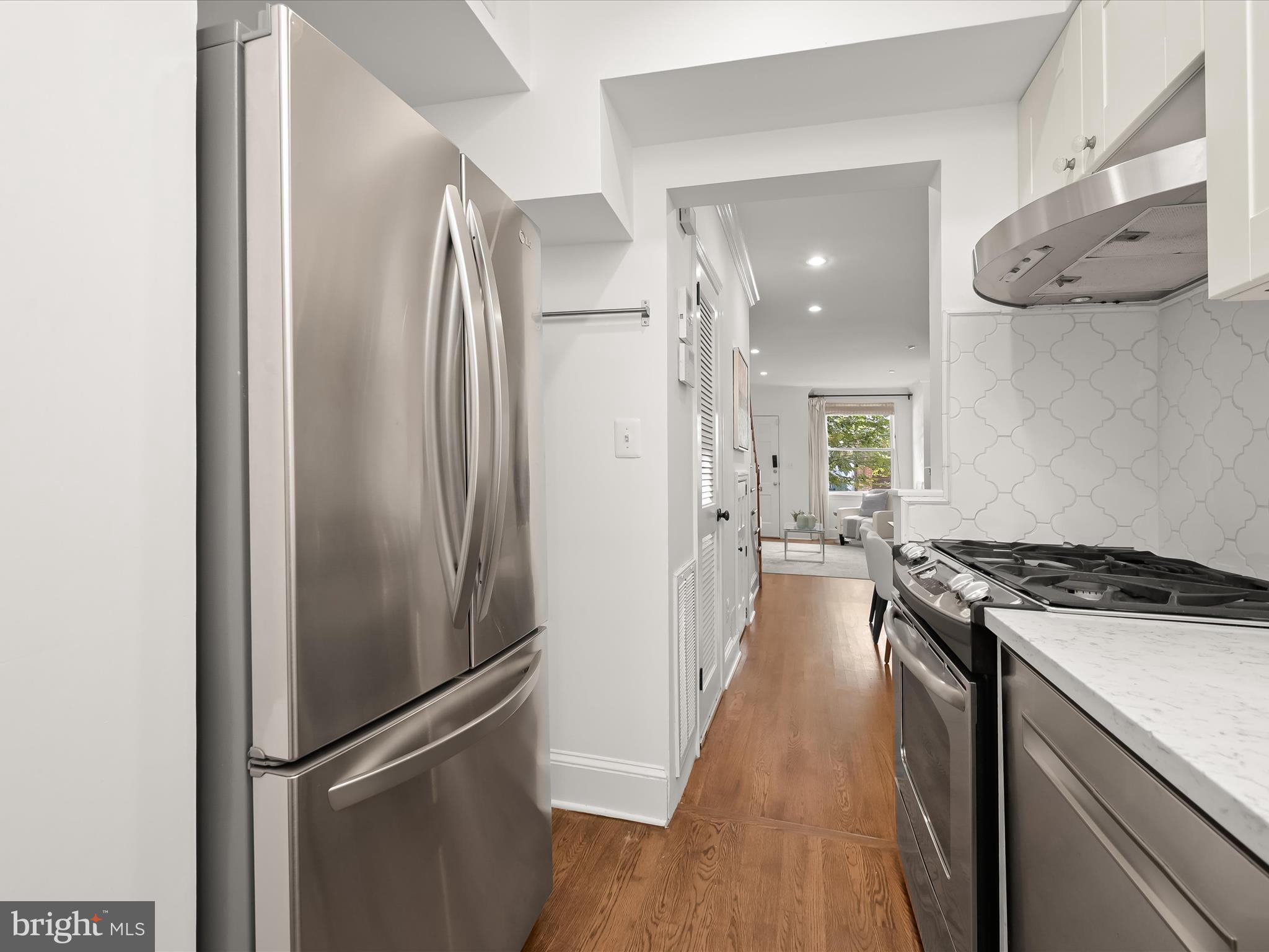 3407 Q Street Northwest Washington, DC 20007 - Photo 15 of 27 a kitchen with stainless steel appliances granite countertop a refrigerator and a stove