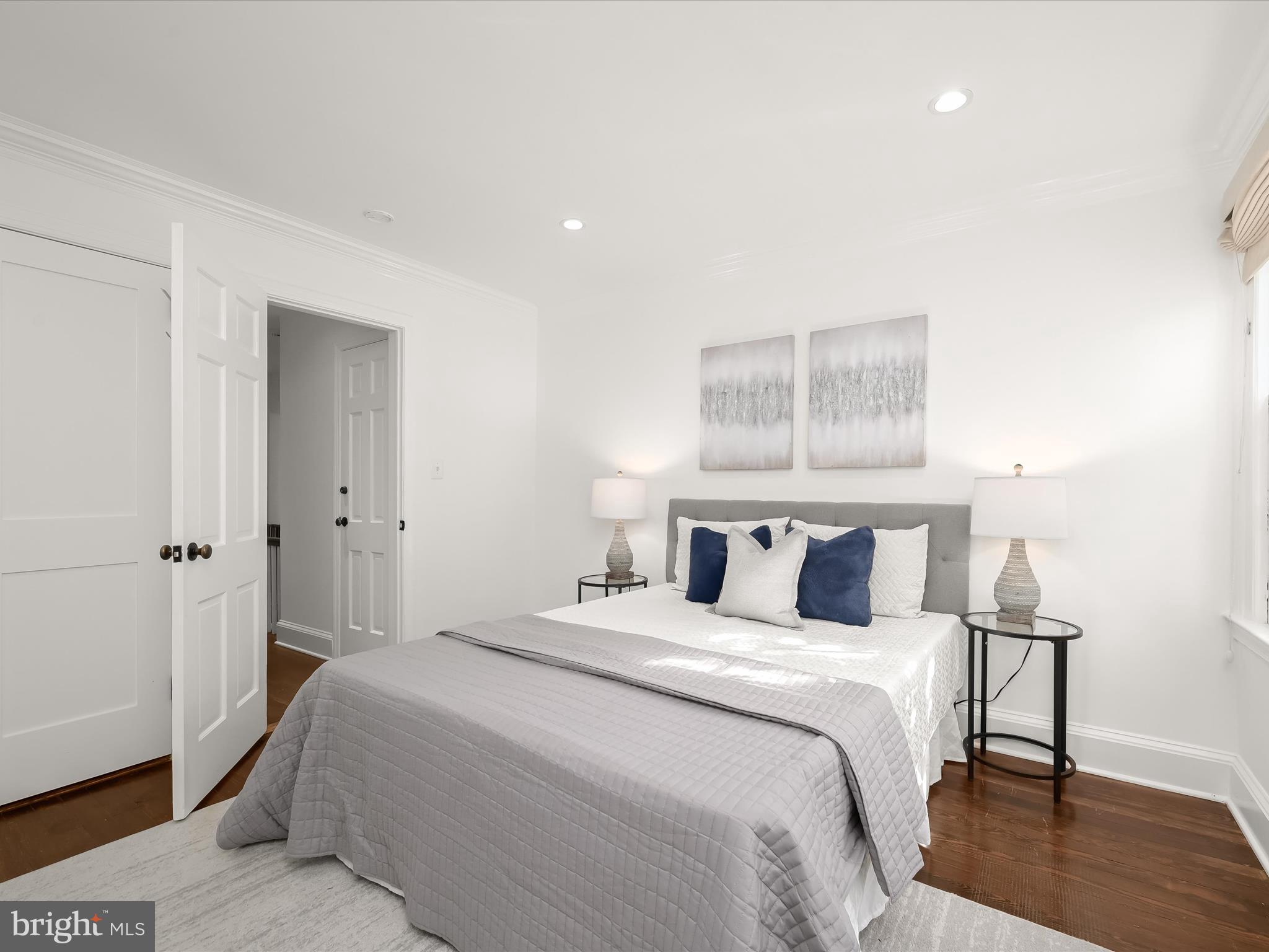 3407 Q Street Northwest Washington, DC 20007 - Photo 18 of 27 a bedroom with a bed and a mirror