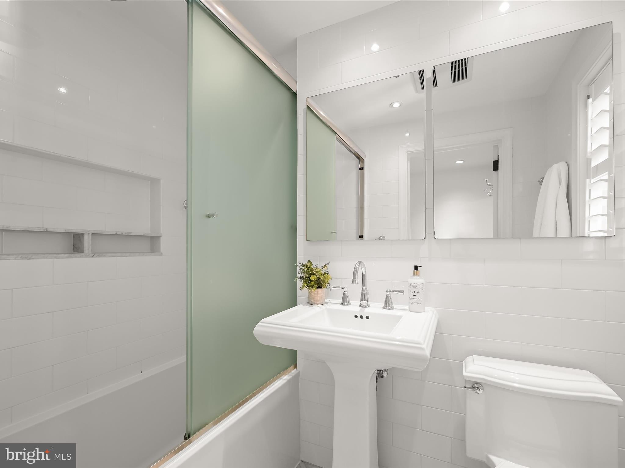 3407 Q Street Northwest Washington, DC 20007 - Photo 20 of 27 a bathroom with a sink toilet and mirror