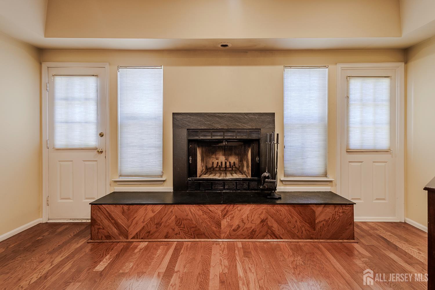 412 Hawkshead Way Somerset, NJ 08873 - Photo 15 of 35 a room with a fireplace and wooden floor