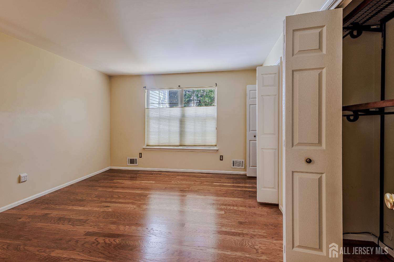 412 Hawkshead Way Somerset, NJ 08873 - Photo 20 of 35 a view of an empty room with wooden floor and a window