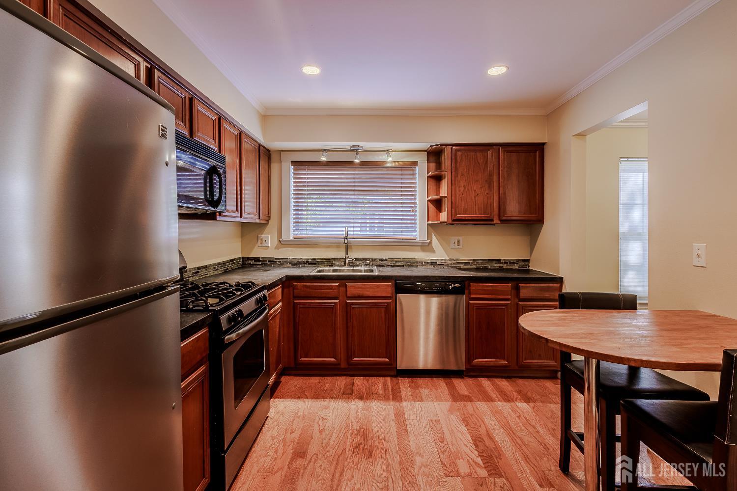 412 Hawkshead Way Somerset, NJ 08873 - Photo 9 of 35 a kitchen with stainless steel appliances granite countertop a stove a sink dishwasher and a refrigerator