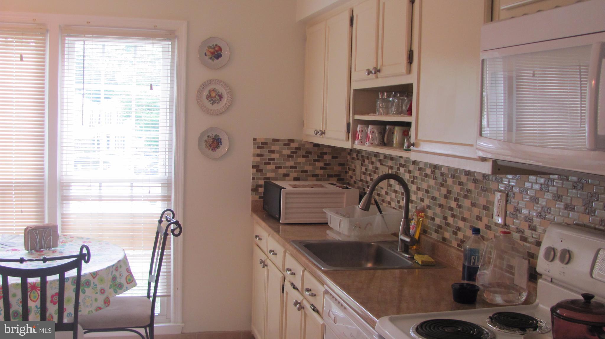 12705 Turquoise Terrace Silver Spring, MD 20904 - Photo 3 of 24 a kitchen with sink cabinets and window