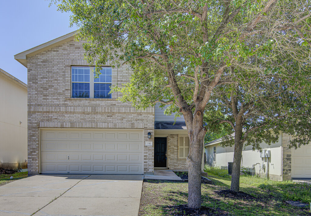 236 Black Forest Road Buda, TX 78610 - Photo 1 of 31 a front view of a house with a garden
