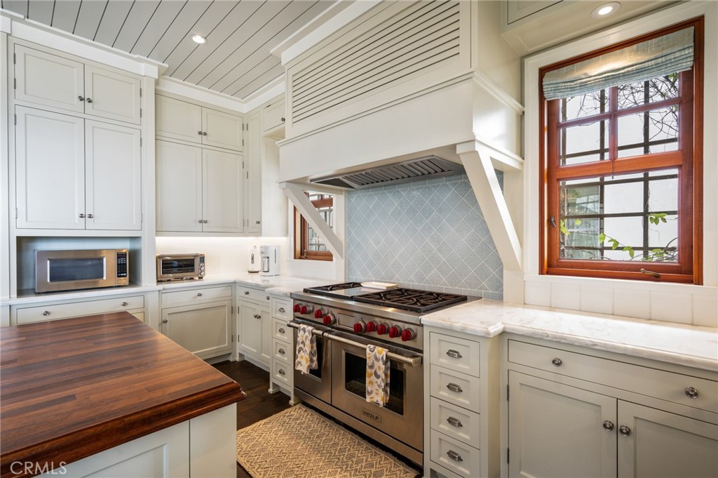 212 The Strand Manhattan Beach, CA 90266 - Photo 17 of 75 a kitchen with granite countertop a stove and a sink