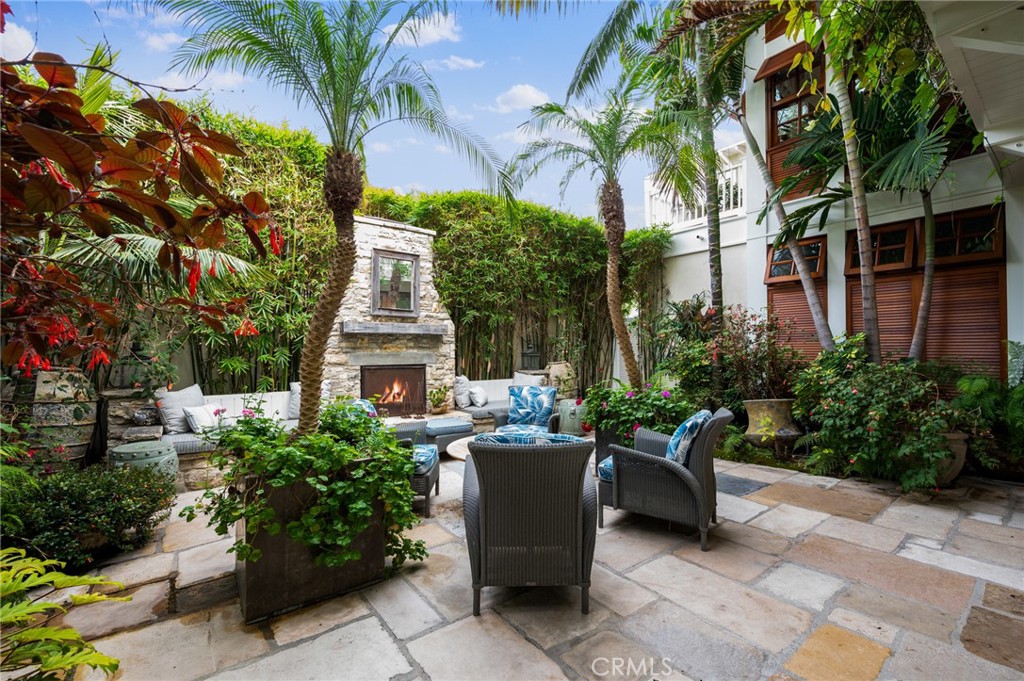 212 The Strand Manhattan Beach, CA 90266 - Photo 26 of 75 a view of a patio with table and chairs potted plants and palm tree