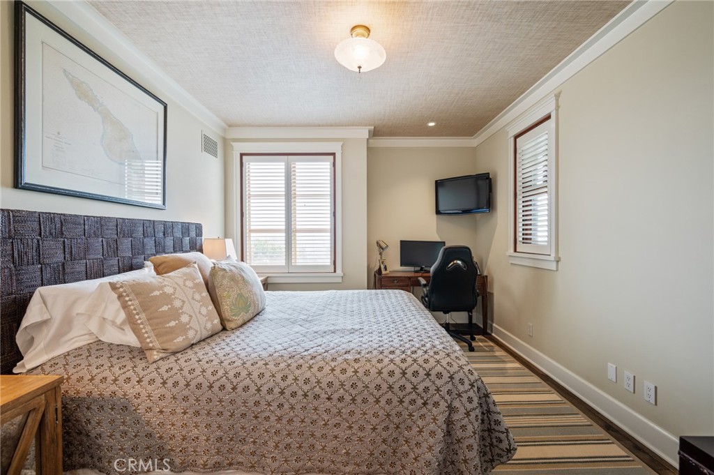 212 The Strand Manhattan Beach, CA 90266 - Photo 35 of 75 a bedroom with a bed and window