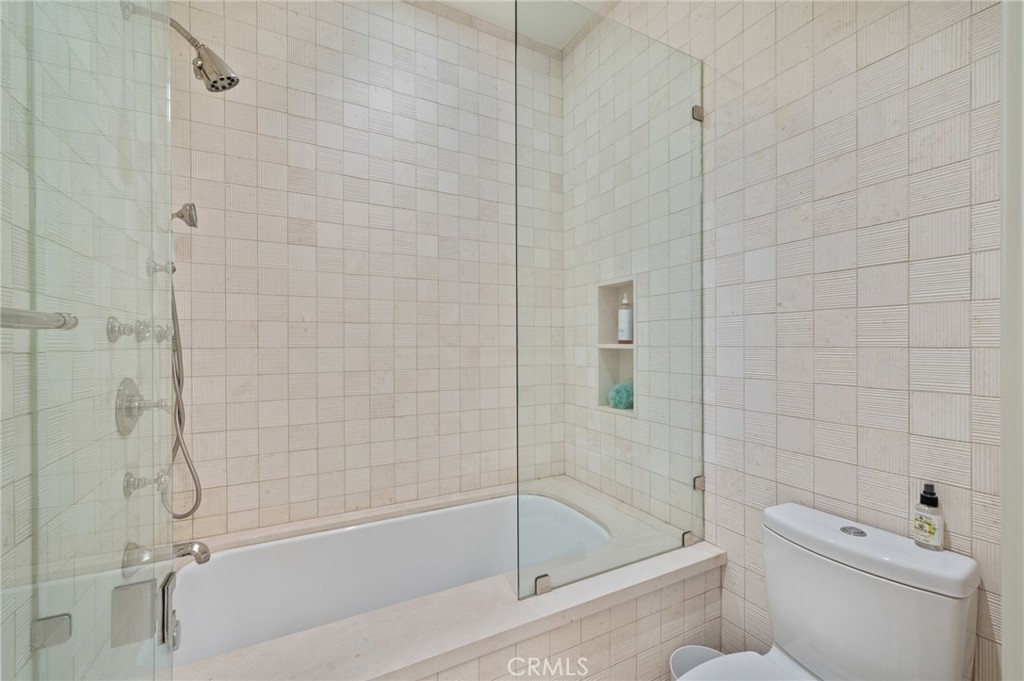 212 The Strand Manhattan Beach, CA 90266 - Photo 36 of 75 a bathroom with a bathtub and a toilet