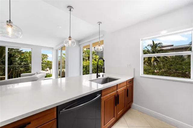 a kitchen with kitchen island a sink and a large window