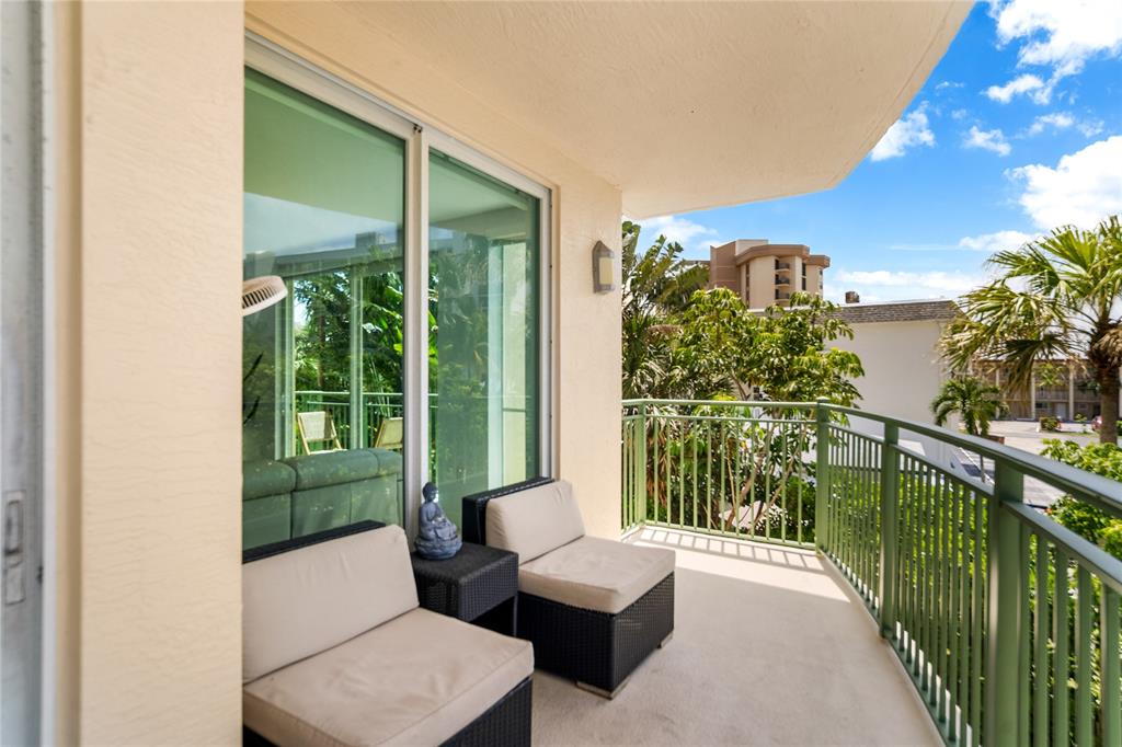 3210 Northeast 5th Street, Unit 203 Pompano Beach, FL 33062 - Photo 23 of 61 a balcony filled with furniture