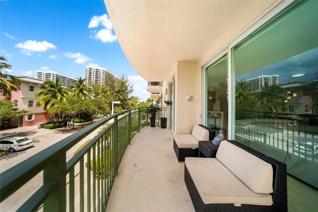 a living room with patio furniture and a floor to ceiling window