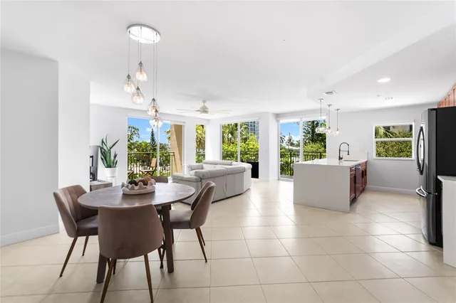 a view of a dining room with furniture and a chandelier