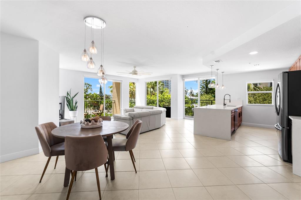 3210 Northeast 5th Street, Unit 203 Pompano Beach, FL 33062 - Photo 3 of 61 a view of a dining room with furniture and a chandelier