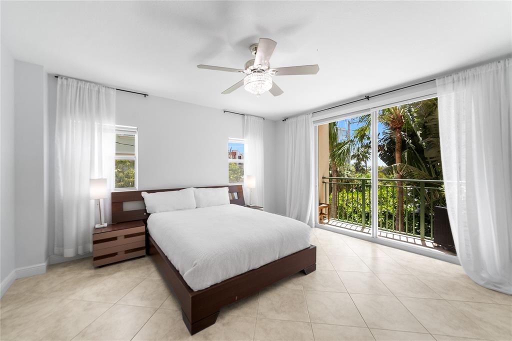 3210 Northeast 5th Street, Unit 203 Pompano Beach, FL 33062 - Photo 37 of 61 a bedroom with a bed and a large window