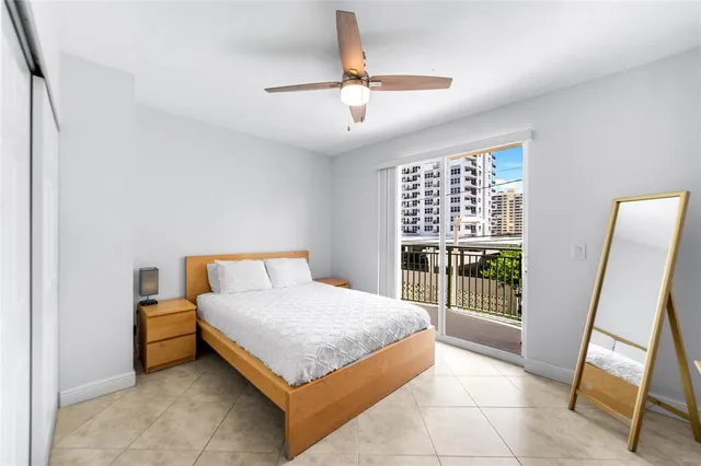 a view of a balcony with a floor to ceiling window next to a tall building