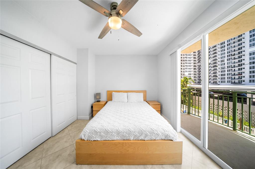 3210 Northeast 5th Street, Unit 203 Pompano Beach, FL 33062 - Photo 43 of 61 a bed sitting in a room next to a window