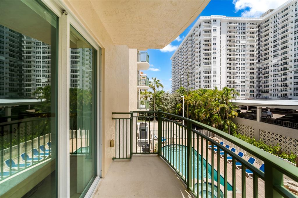 3210 Northeast 5th Street, Unit 203 Pompano Beach, FL 33062 - Photo 50 of 61 a view of a balcony with a floor to ceiling window next to a tall building