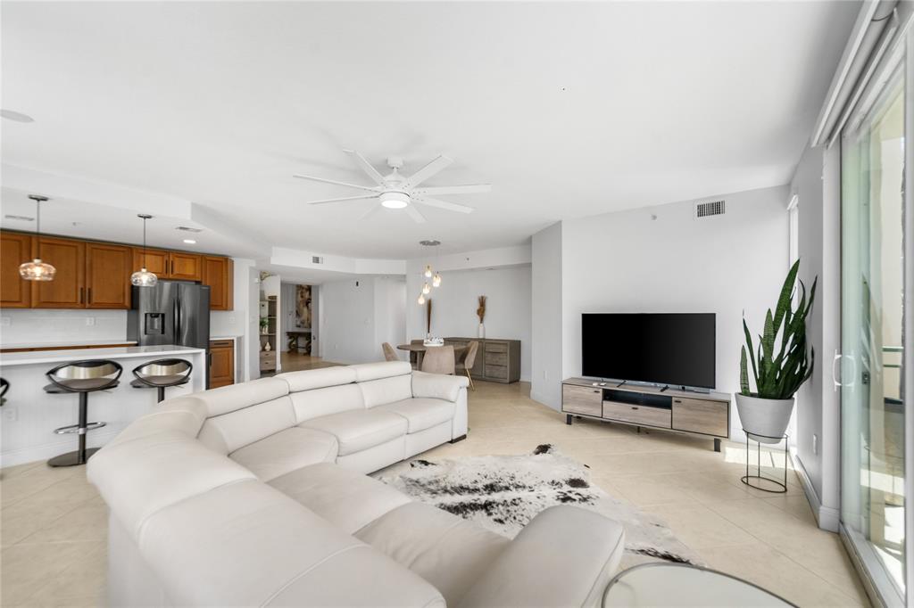 3210 Northeast 5th Street, Unit 203 Pompano Beach, FL 33062 - Photo 5 of 61 a living room with furniture and a flat screen tv
