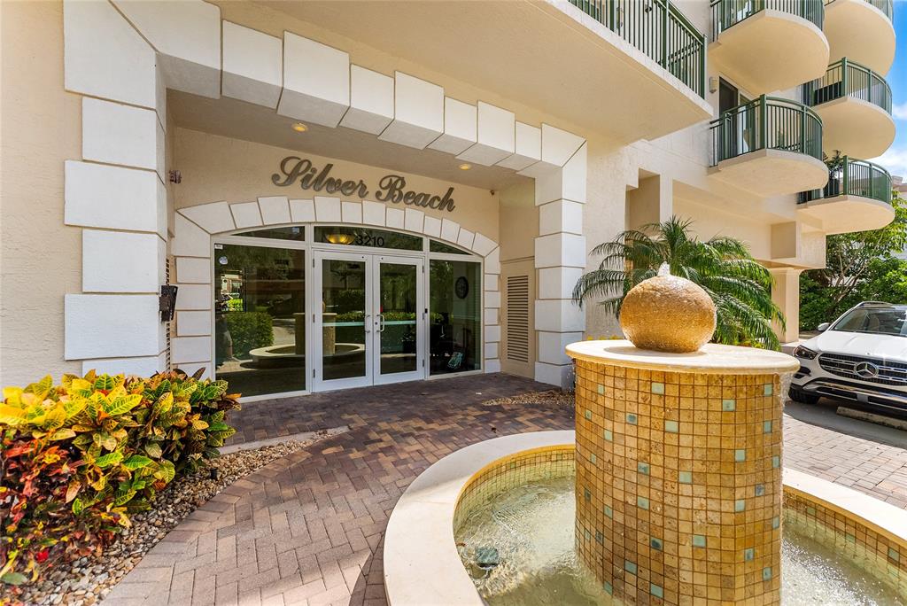 3210 Northeast 5th Street, Unit 203 Pompano Beach, FL 33062 - Photo 52 of 61 a front view of a house with swimming pool