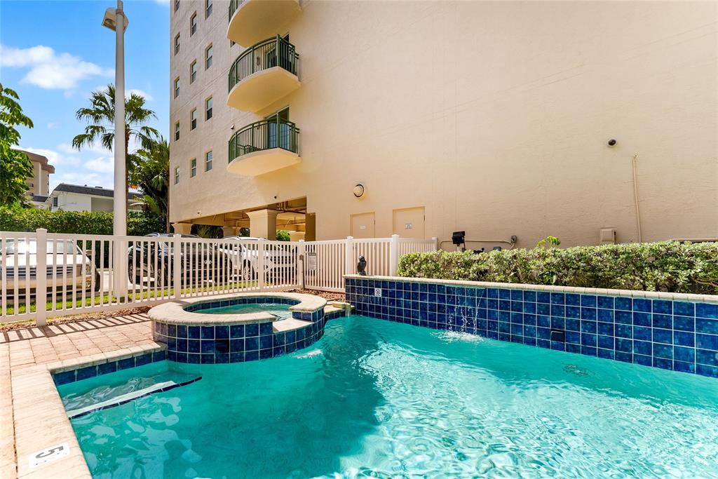3210 Northeast 5th Street, Unit 203 Pompano Beach, FL 33062 - Photo 59 of 61 a view of a swimming pool with a deck and furniture