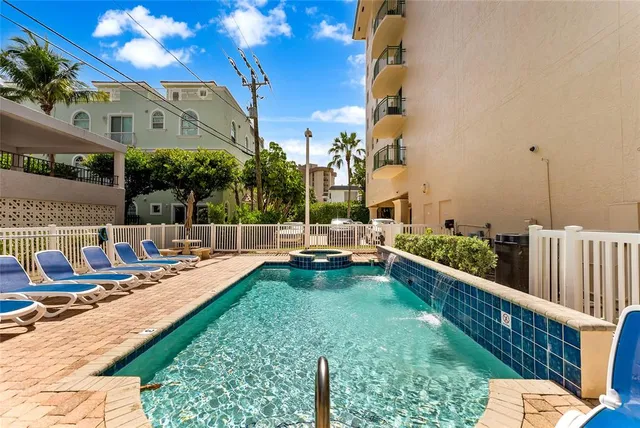 a view of swimming pool with outdoor seating and plants