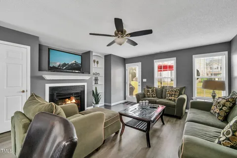 a living room with furniture fireplace and a window