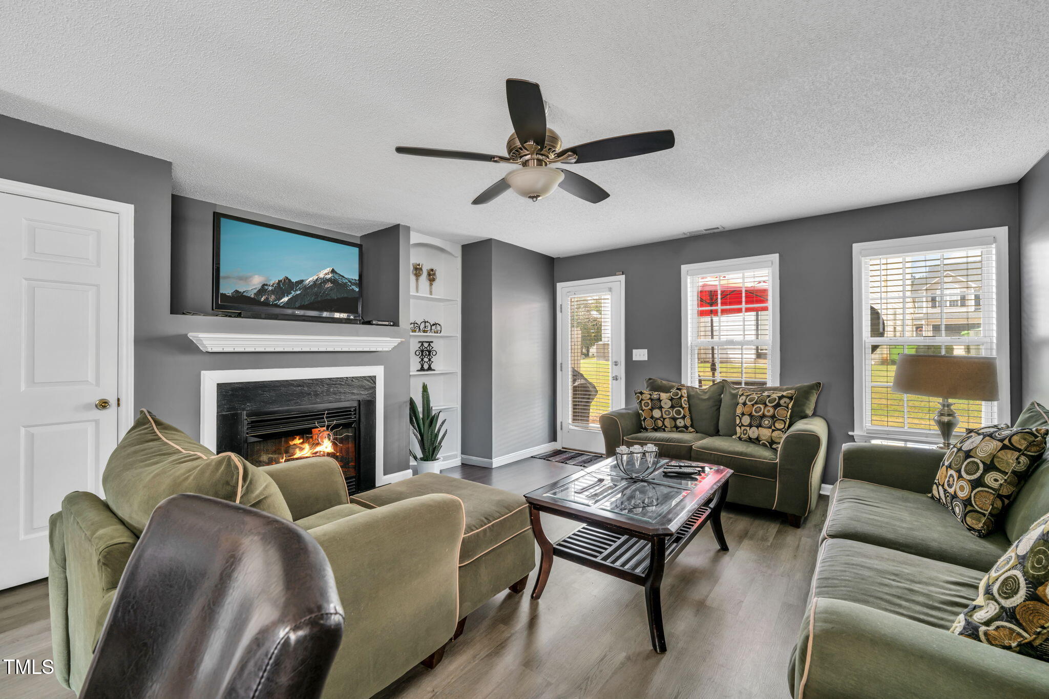 a living room with furniture fireplace and a window
