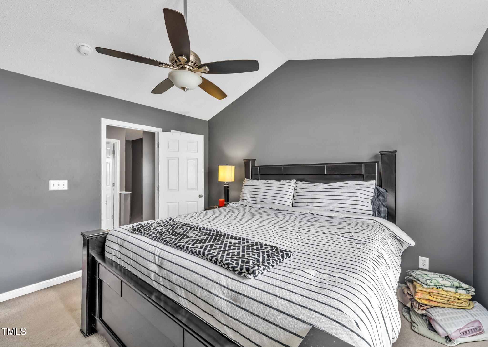 2203 Whistling Straits Way Raleigh, NC 27604 - Photo 13 of 32 a bedroom with a large bed and a chandelier